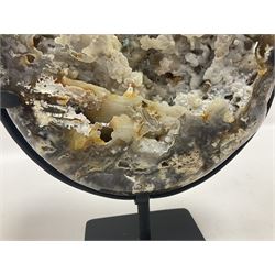 Large agate geode with quartz crystals to the centre, upon a metal stand, H35cm 