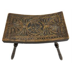 Late 19th century oak stool, rectangular dished top relief carved with floral lunettes and central insignia, on turned splayed supports