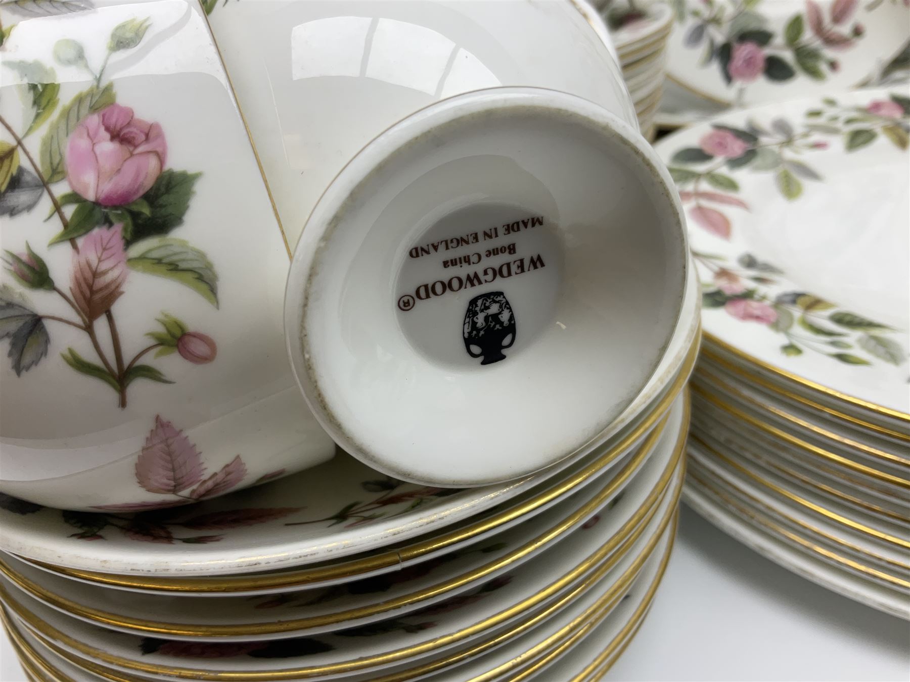 Wedgwood Hathaway Rose pattern tea and dinner wares, comprising twelve saucers, sixteen teacups, twenty tea plates, jug, sucrier, thirteen shallow bowls, sauce boat and saucer, two lidded tureens, larger jug, ten dinner plates, nine smaller plates and two large oval serving dishes