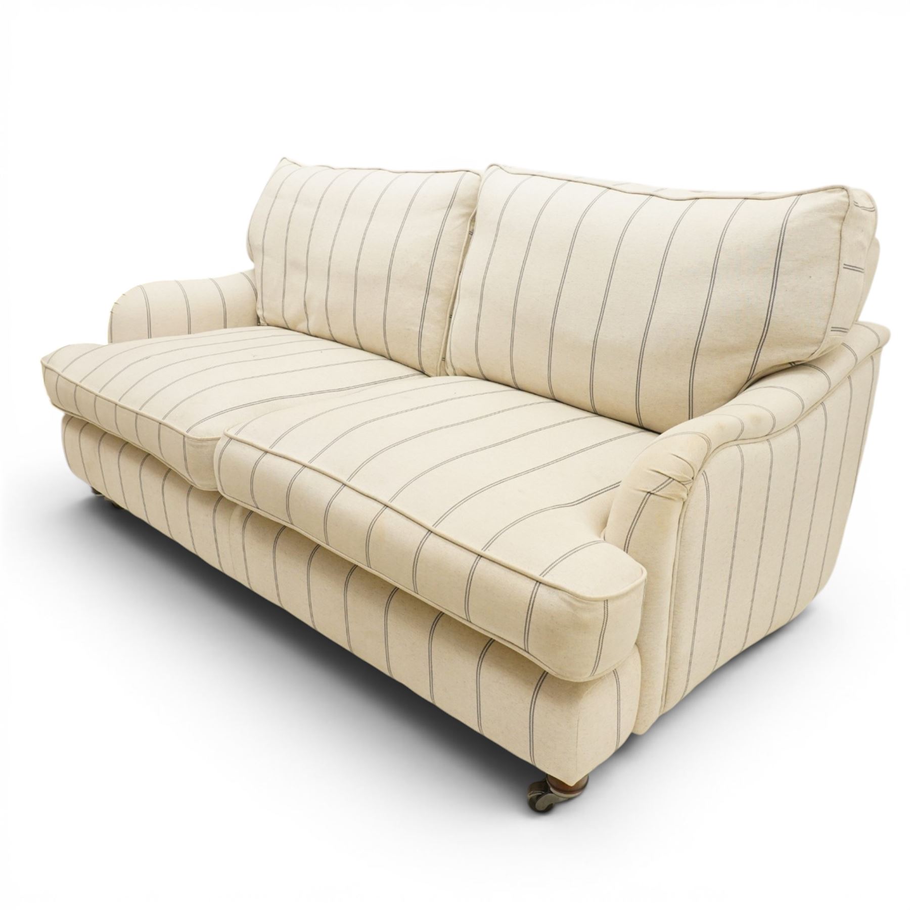 20th century Howard shape two seat sofa, deep seat sofa in cream and grep striped upholstery, raised on dark supports terminating in front castors 