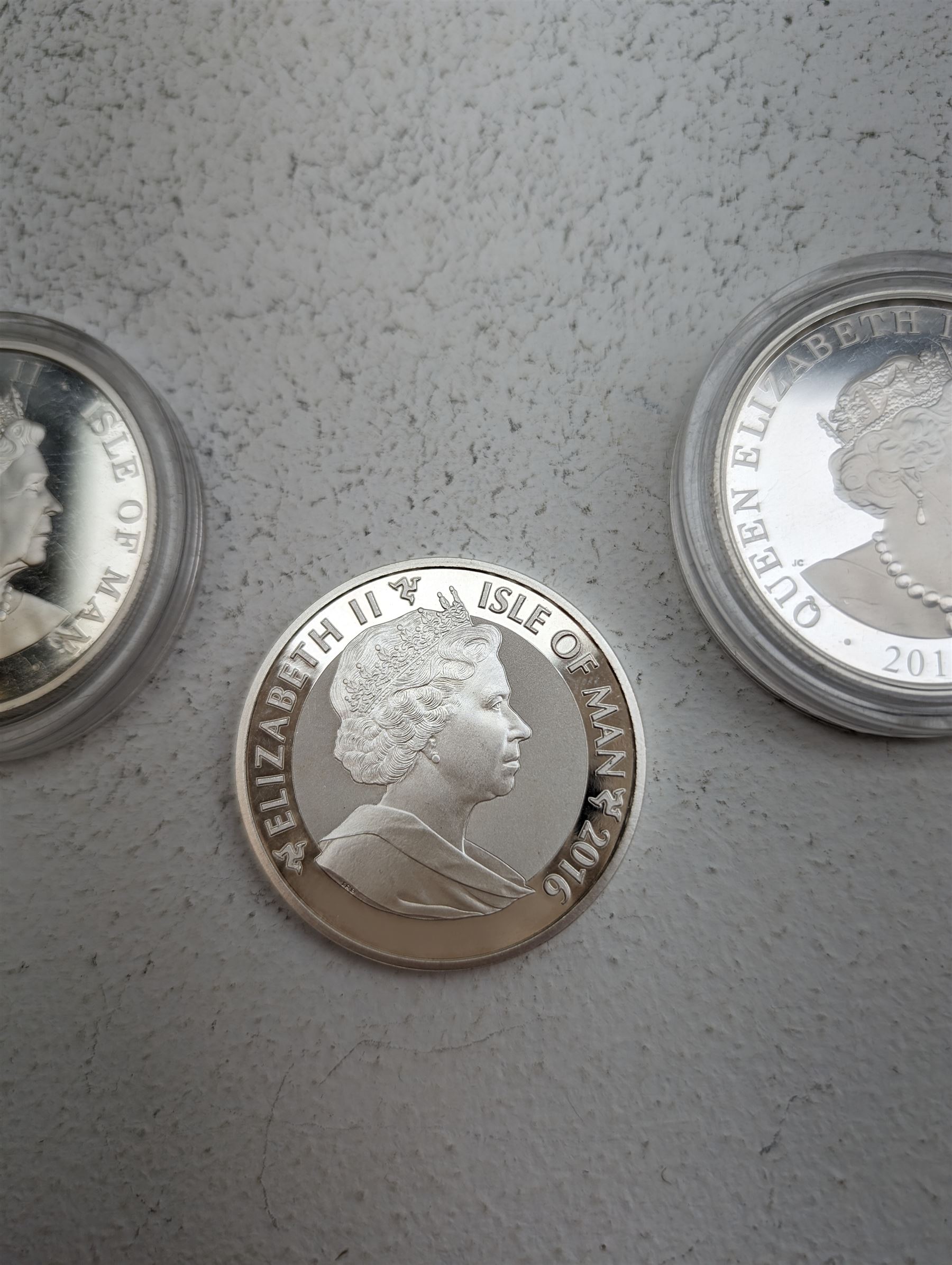 Three Queen Elizabeth II Isle of Man one ounce fine silver coins, comprising 2016, 2018 one angels and 2018 one noble 