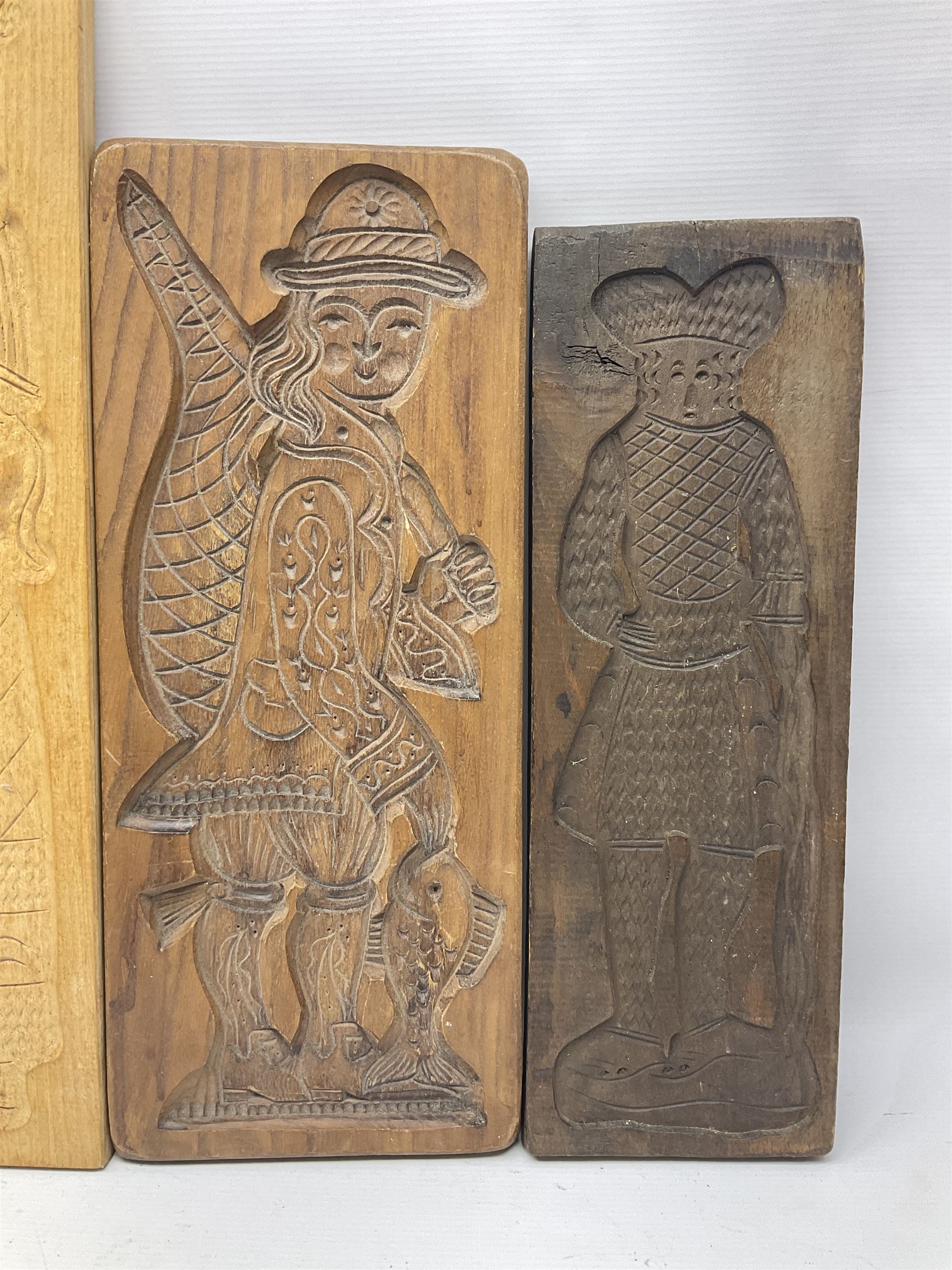 Eight 20th century hardwood Dutch folk art Speculaasplank or biscuit moulds, most examples typically carved with figures in traditional dress, tallest H60cm
