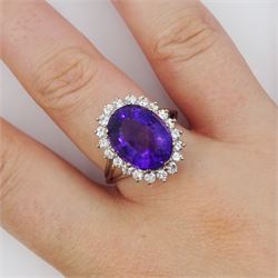 18ct white gold oval cut amethyst and round brilliant cut diamond cluster ring, amethyst approx 5.55 carat, total diamond weight approx 0.60 carat