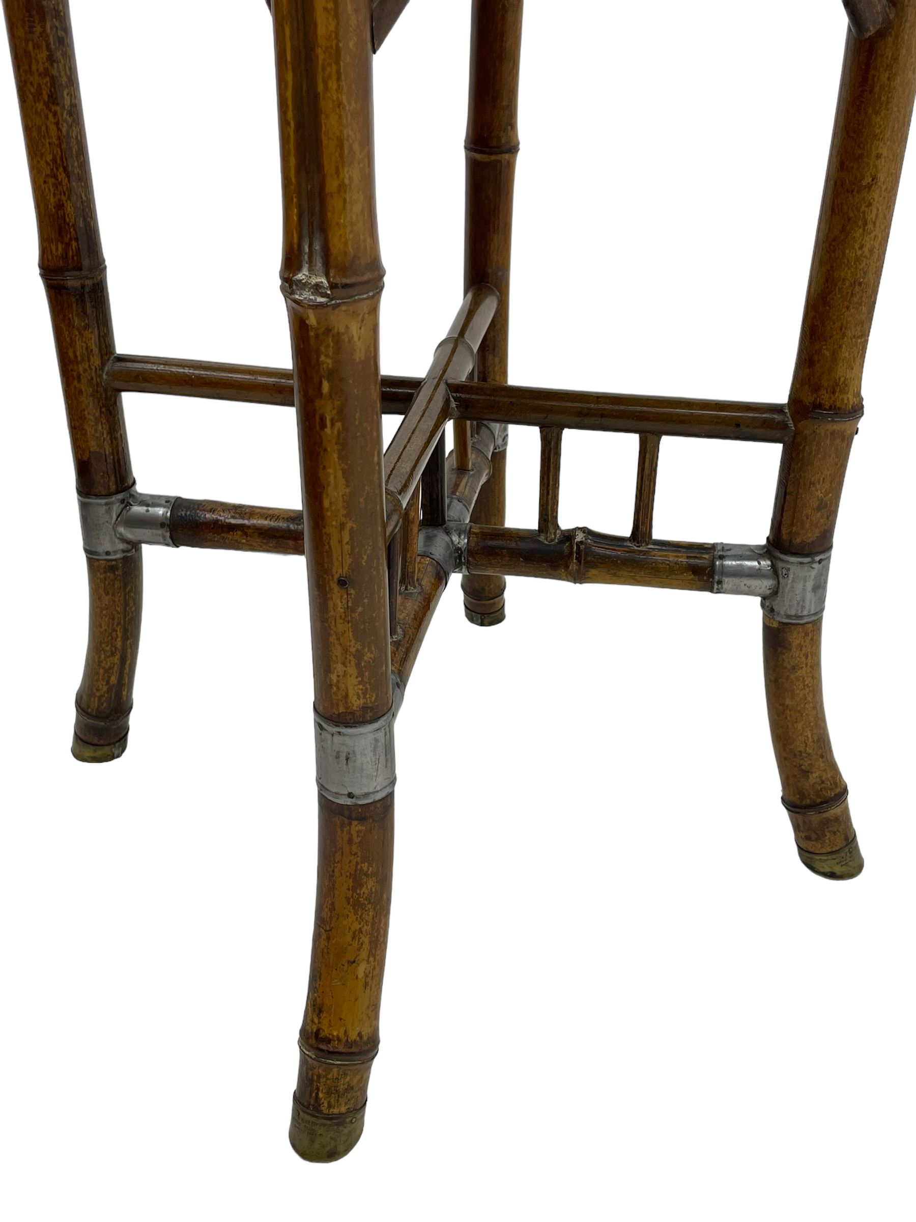 W.F. Needham - Victorian bamboo occasional table, octagonal lacquered top, the bamboo joined by metal brackets, brass cups stamped 'W.F Needham'