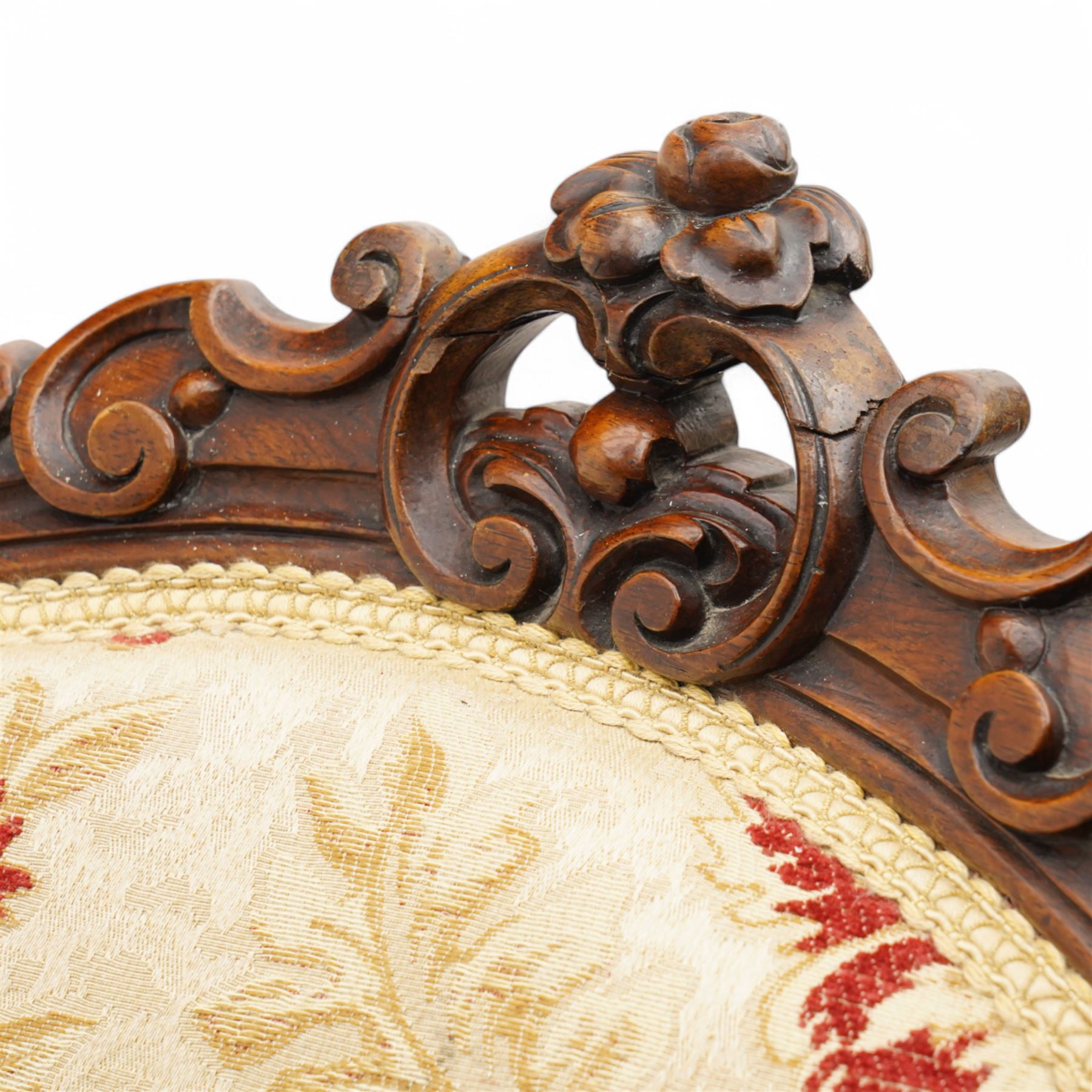 Victorian Ladies and Gentleman's carved walnut drawing room chairs, each with shaped cresting rail carved with scrolls and flowerheads, upholstered in pale gold floral fabric, raised on foliate-carved cabriole supports terminating to brass and ceramic castors
