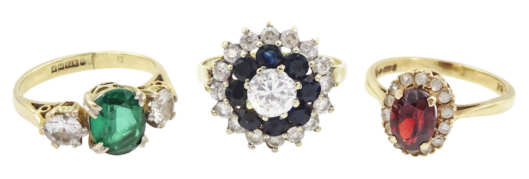 Three gold stone set rings including garnet, cubic zirconia and sapphire, all hallmarked 9ct