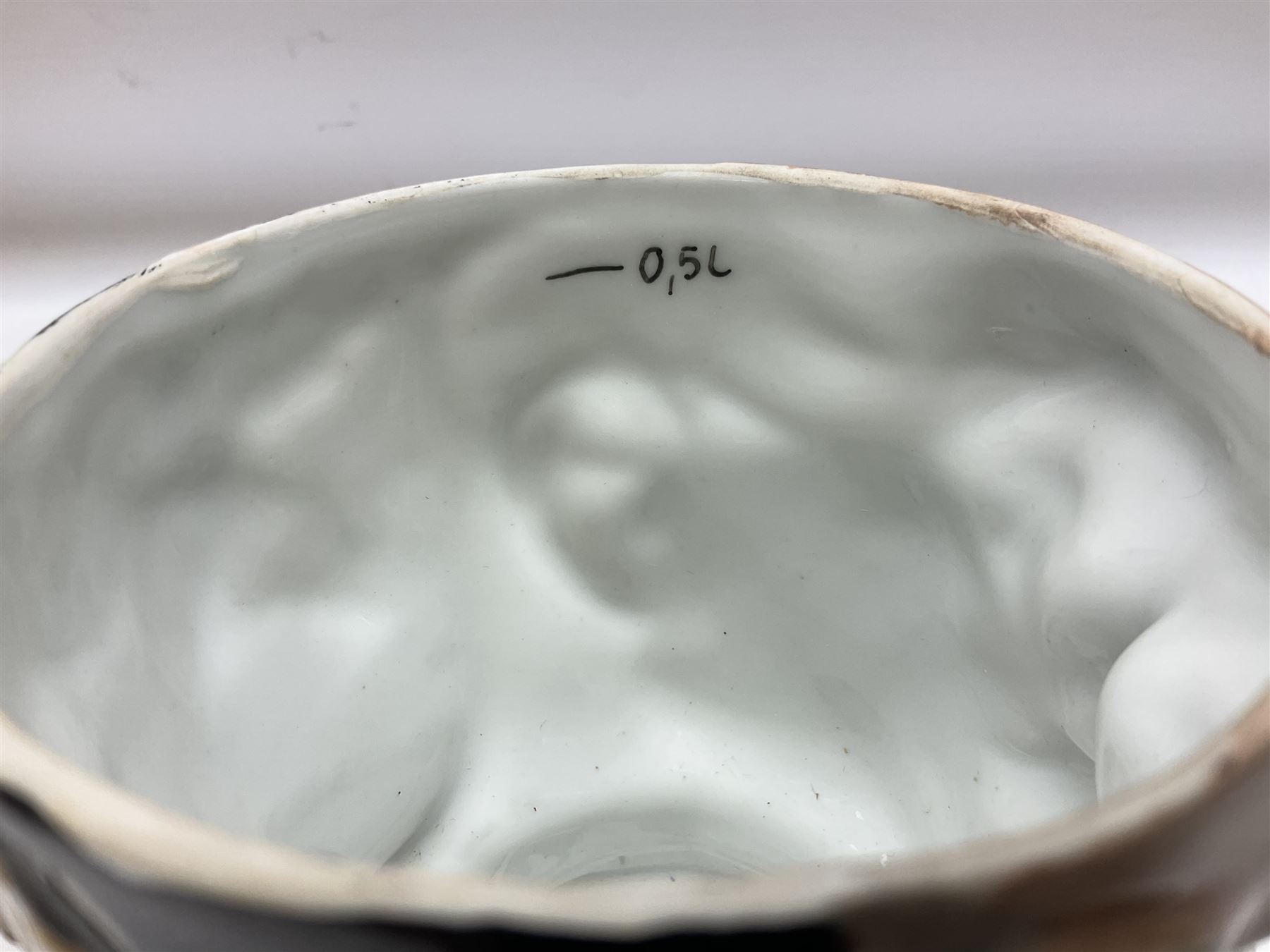 Otto Von Bismarck figural 0.5l stein, his black pickelhaube helmet with chrome spike serving as the lid, in green uniform and gilt detail throughout, pewter thumb hinge, with blue hash Musterschutz type mark, H18cm