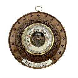 German- Late 19th century aneroid Barometer in a carved mahogany case with pendants and finials, 4” open dial register and mercury thermometer, with another early Edwardian aneroid barometer in a circular carved  walnut case with a 4