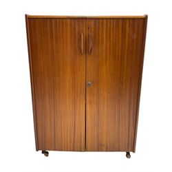 Mummenthaler & Meier - mid-20th century circa. 1960s teak 'Magic Box' folding desk cabinet, the cabinet opens to reveal shelves, writing desk, document holders and lamp, on castors