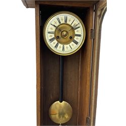 German - early 20th century 8-day spring driven oak cased wall clock, with a two-part dial with a gilt centre and enamel chapter with Roman numerals and minute track, two train striking movement striking the hours and half-hours on a coiled gong.
