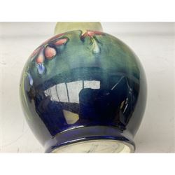 Moorcroft vase of baluster form decorated in the Spring Flowers pattern upon a merging green and blue ground, with impressed and painted marks beneath, H22.5cm