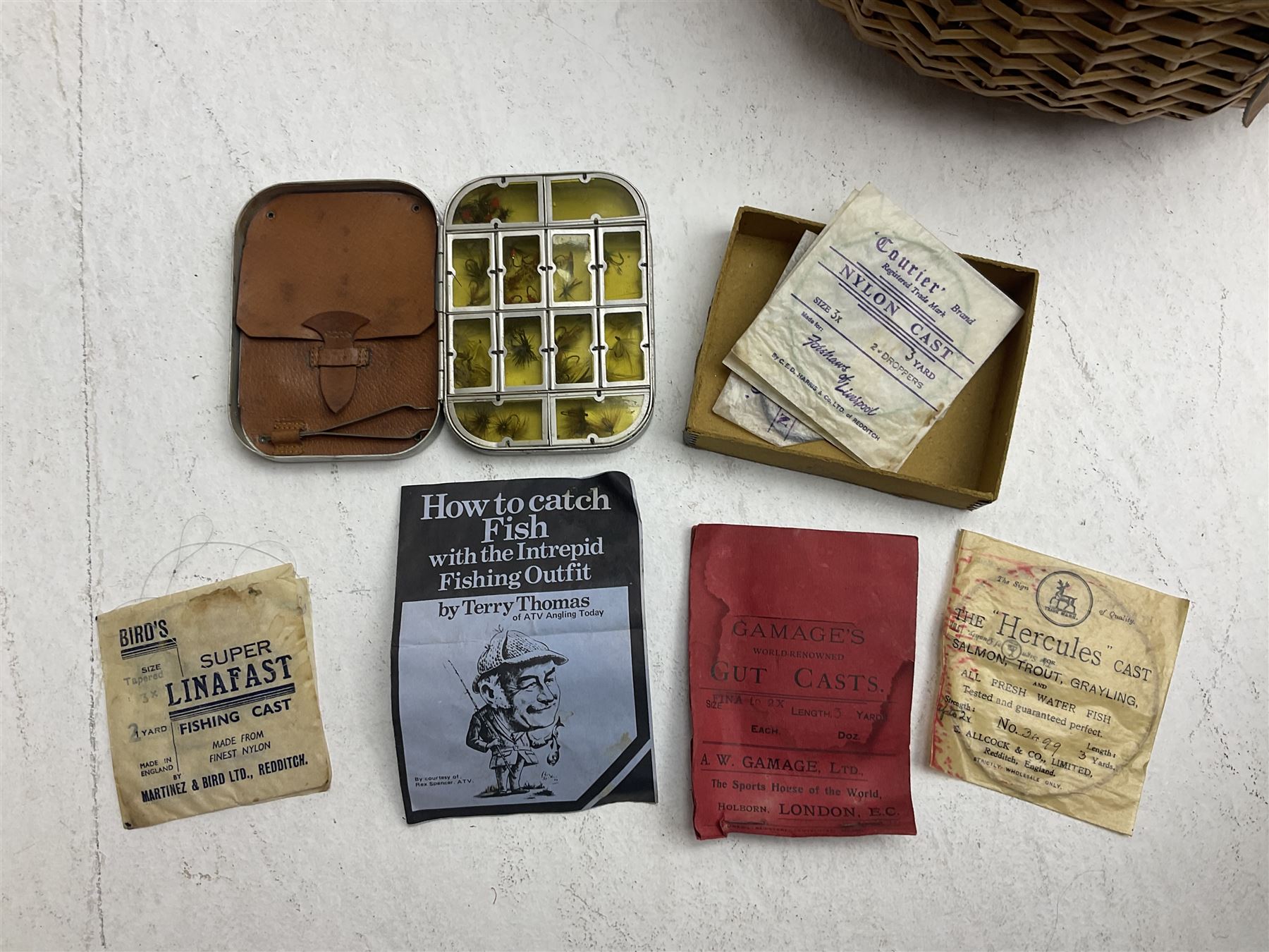 Fishing tackle and accessories housed in two wicker creels, including a landing net, fly tin, small brass reel, other reels to include two Intrepid Boy'o examples, crab lines etc 