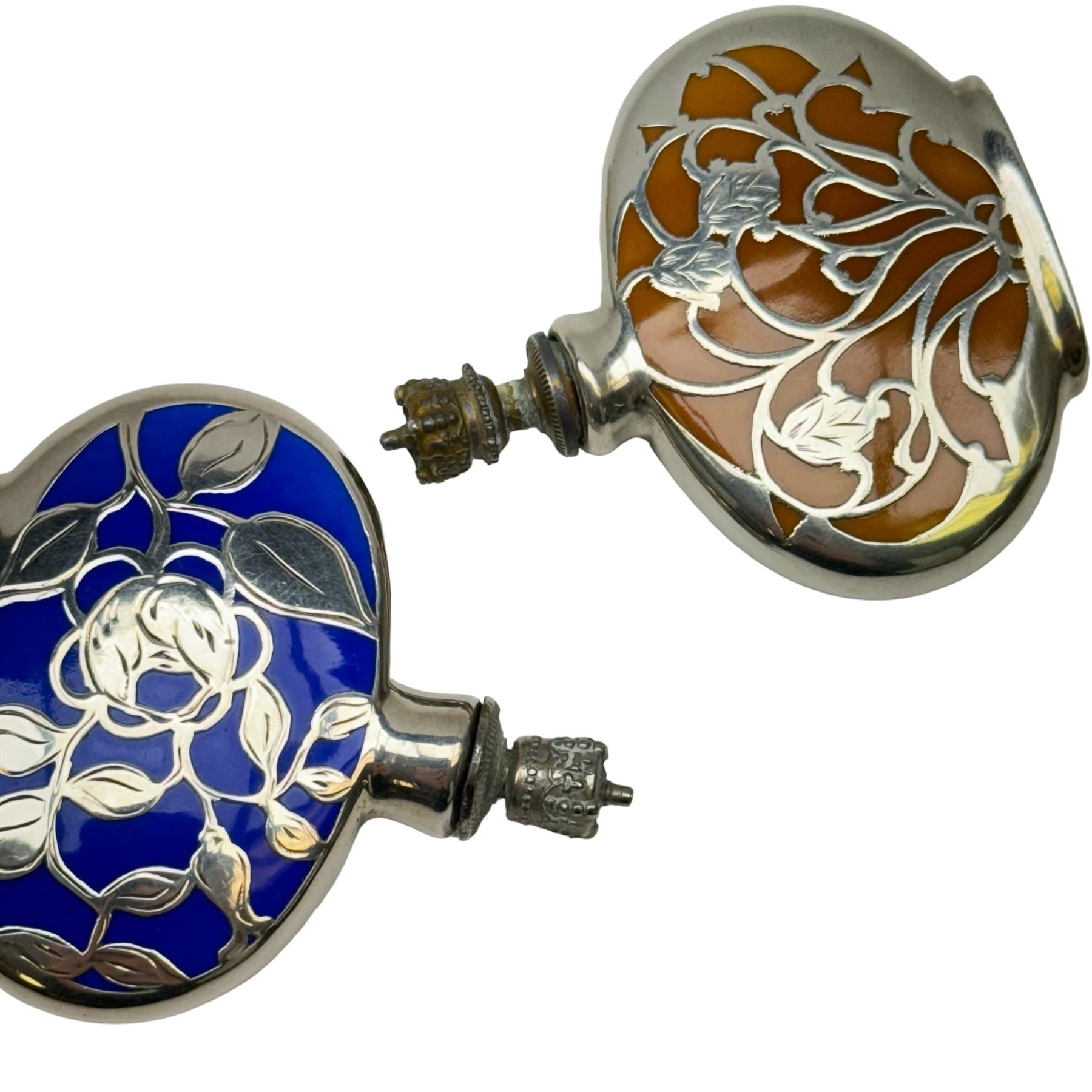 German silver and enamel perfume bottles, each with silver overlay floral decoration, and a crown top stopper, H6cm