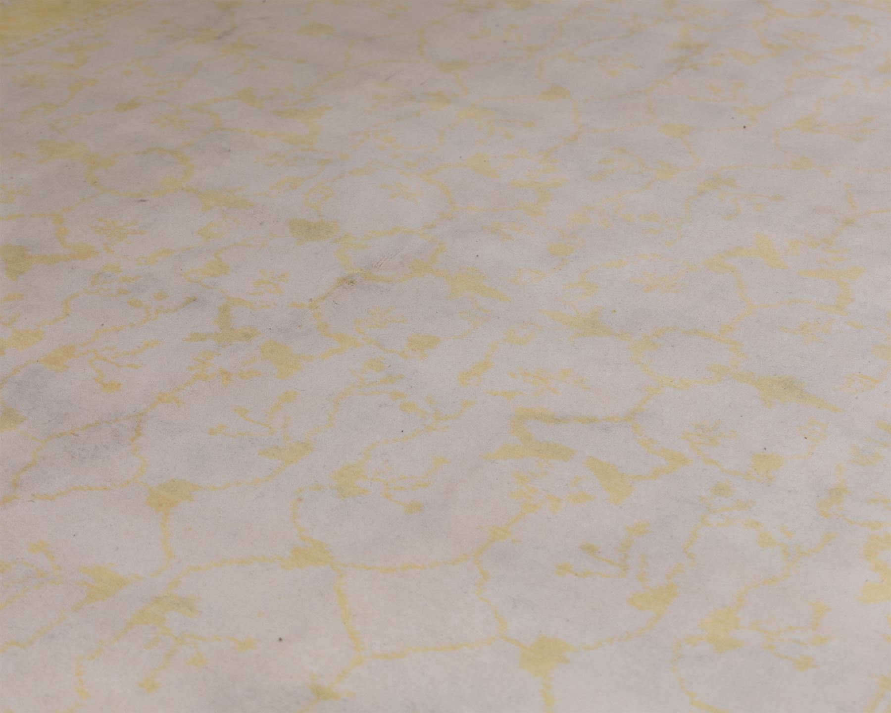 Tibetan wool rug, decorated with a pale cream ground and yellow all-over foliate design, enclosed by a broad yellow floral border and narrow inner guard band