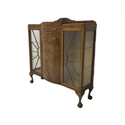 Mid-20th century Art Deco style walnut display cabinet, two central drawers over cupboard flanked by two bevel glazed display cabinets with sunburst astragal glazing, on ball and claw cabriole feet