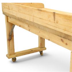 Mid-20th century pitch pine and beech bakers table, three quarter galleried rectangular plank top, three drawer pedestal with iron handles and runners, square supports with iron spandrel, raised on castors 