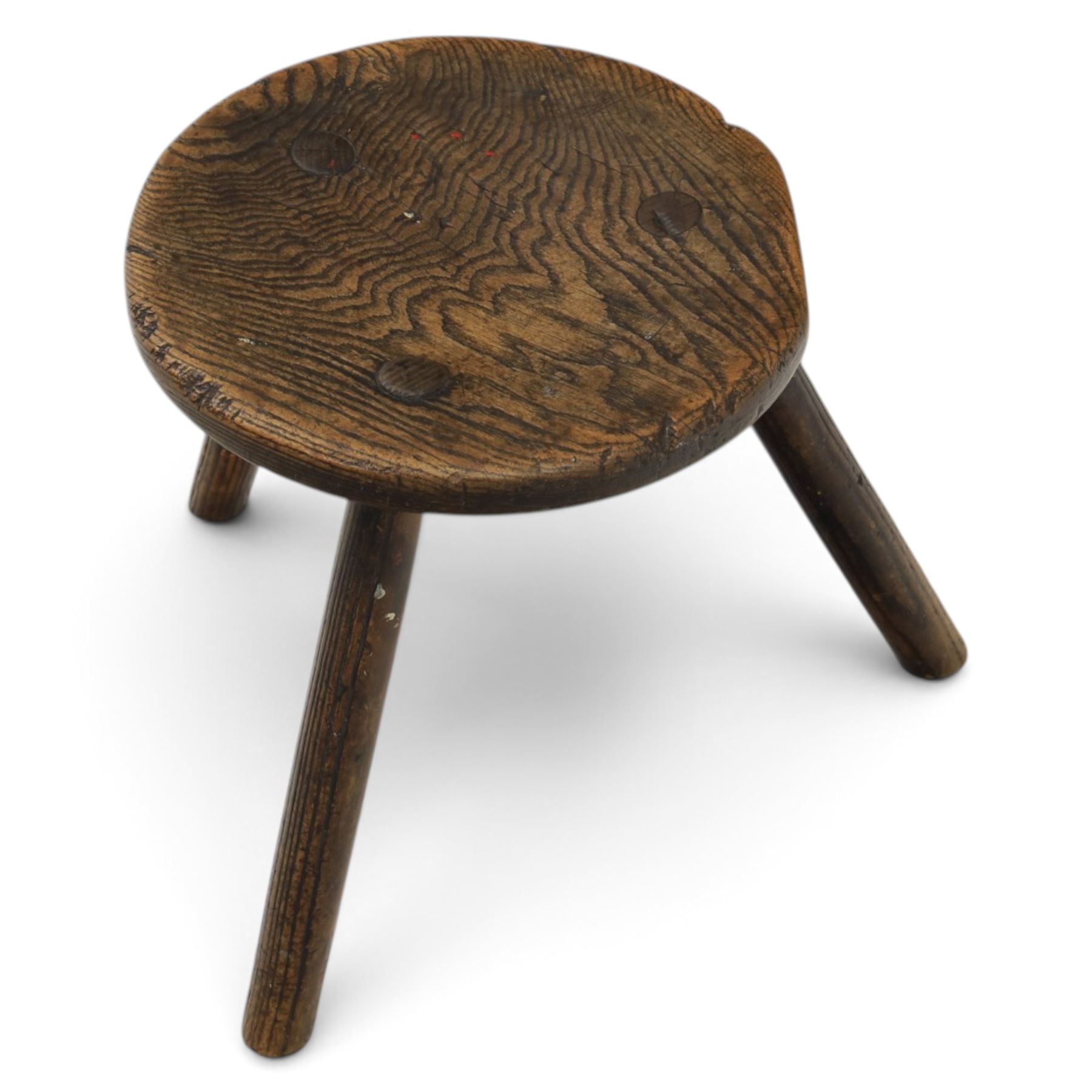 18th century ash and elm milking stool, circular figured top raised on cylindrical supports