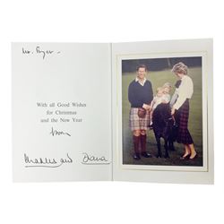 The Prince and Princess of Wales (Charles and Diana) - signed Christmas card, inscribed to Mr. Fryer, signed in ink by Charles and Diana; mounted colour photograph depicting Charles and Diana with young Princes William and Harry; gilt crests to upper board; complete with original envelope, postmarked Buckingham Palace, 17 December 1985