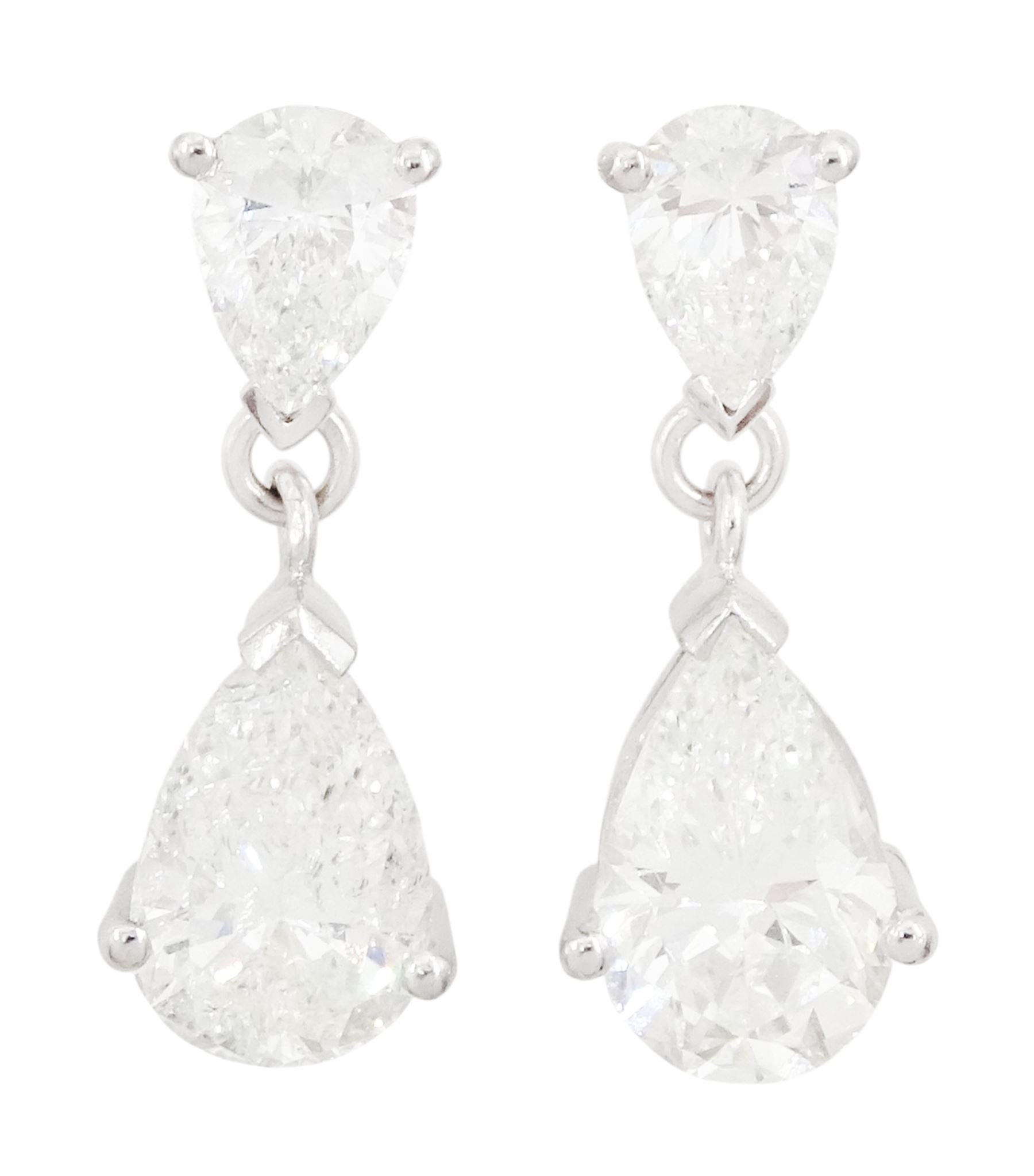 Pair of 18ct white gold two stone pear cut diamond pendant stud earrings, hallmarked, the two largest diamonds of approx 1.70 carat and 1.55 carat, total diamond weight approx 4.40 carat