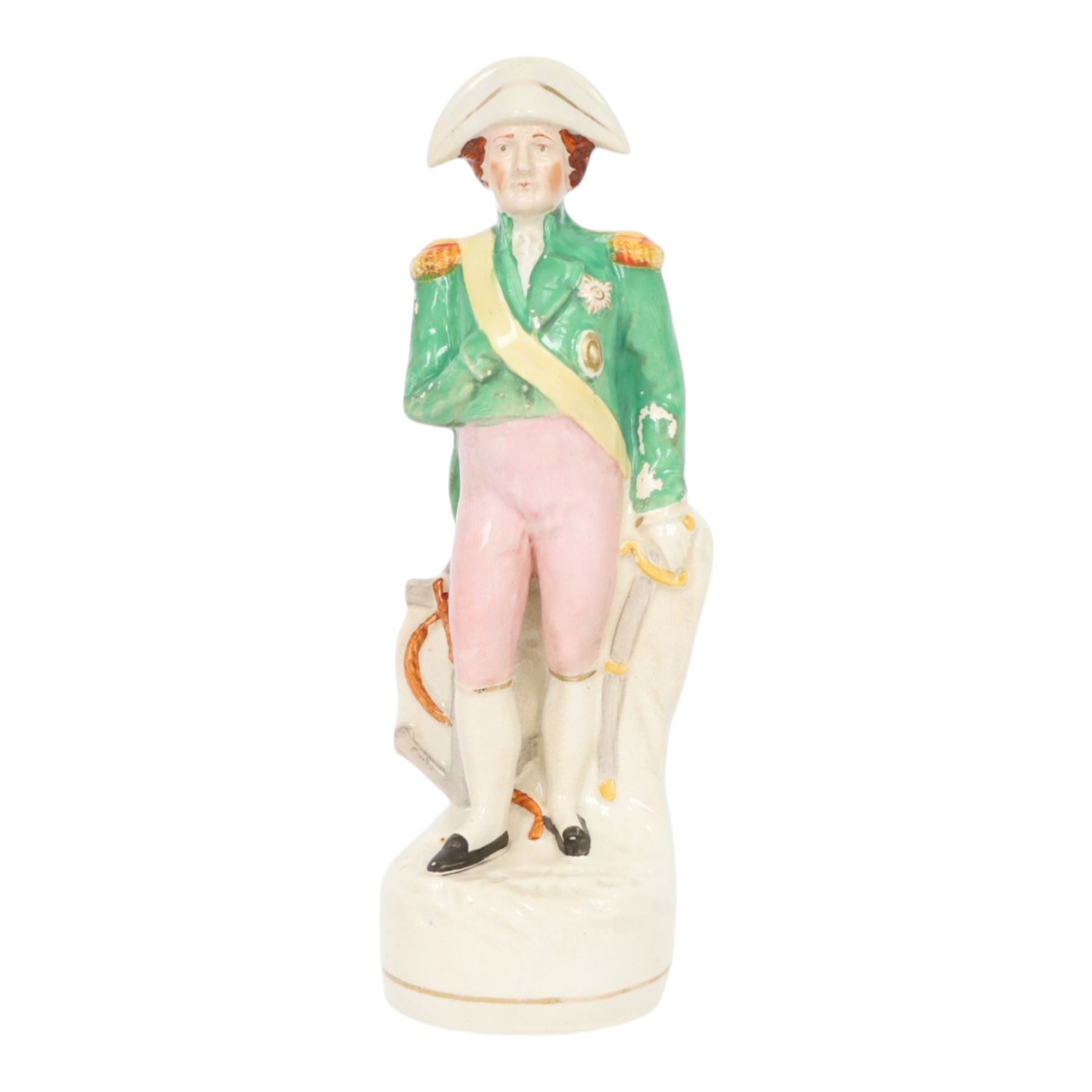 Rare mid 19th century Staffordshire pottery figure of Admiral Lord Nelson, modelled standing in uniform with green tunic, beside anchor, H27cm