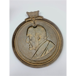 A mid-Victorian cast iron memorial portrait plaque, of Arthur Wellesley, 1st Duke of Wellington, Moulded by Johnsons's Litchurch Works, Derby, head-and-shoulders length and turned to dexter in profile, circular frame surmounted by a ducal coronet, D27.5cm, foundry marks and dated 13th November 1854 to verso; and gilt painted spelter figure of a cavalier on ebonised wooden socle base H48cm (2)
