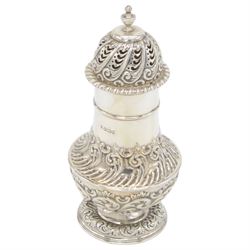 Late Victorian silver sugar caster, of typical waisted form, with embossed scrolling and foliate decoration and urn finial to removable pierced cover, upon circular foot, hallmarked Fenton Brothers, Sheffield 1895, H19cm
