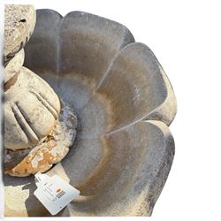 Weathered cast stone garden water feature fountain, the raised central spout with egg-and-dart moulding, within a scalloped basin raised on a lappet pedestal with cylindrical plinth base