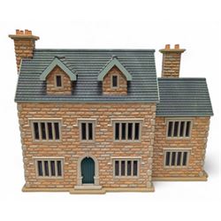 1:24 scale stone effect three-storey cottage dolls house, with green arched door and lattice effect windows, decorated to the interior with wooden floors, wired lighting and fire places, H45cm, W57cm, D26cm