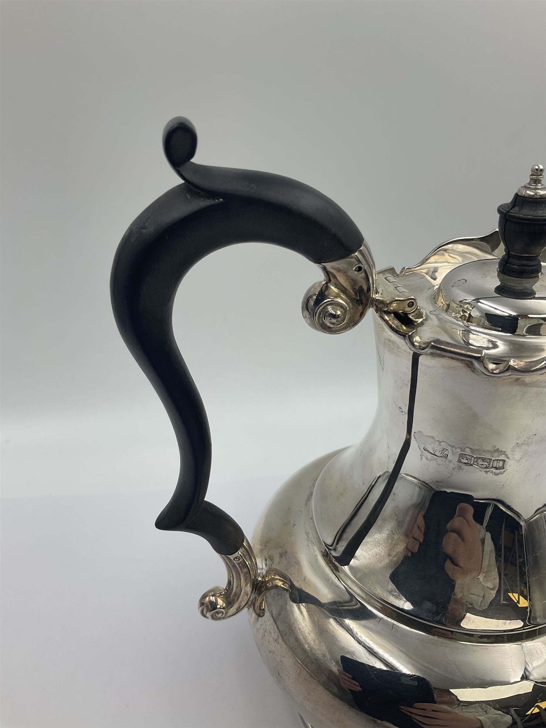 1920s five-piece silver tea service, comprising teapot, coffee pot, hot water pot, twin handled open sucrier and milk jug, each of squat circular form with shaped rim, the teapot, coffee pot and hot water pot each with ebonised handle and finial, the sucrier and milk jug with acanthus capped scroll handles, all upon circular foot, hallmarked R F Mosley & Co, Sheffield 1926 & 1927, tallest H24cm