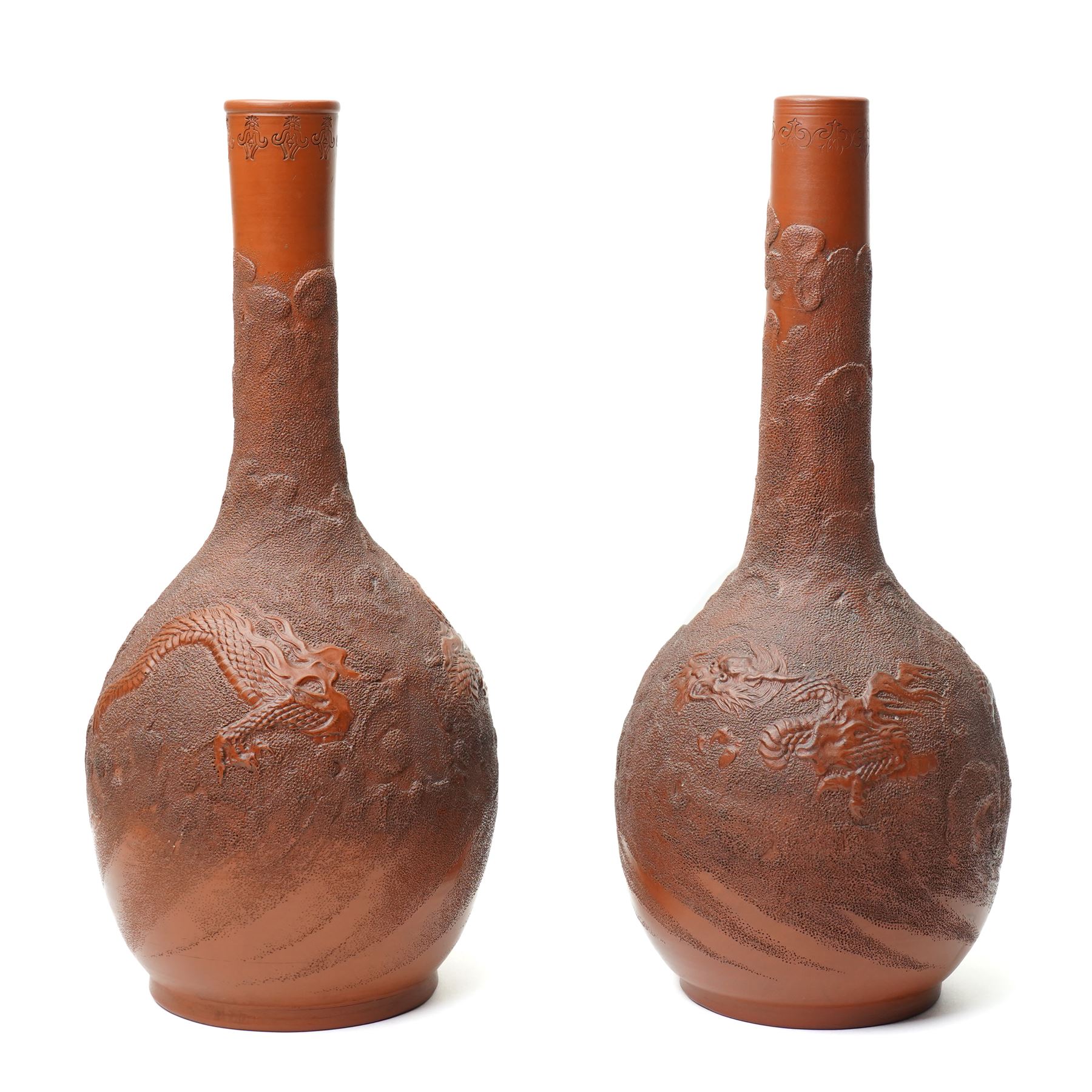 Pair of Chinese redware vases in the Yixing style, early 20th century, decorated with dragons among clouds, one bearing impressed marks to base, H30cm (2)
