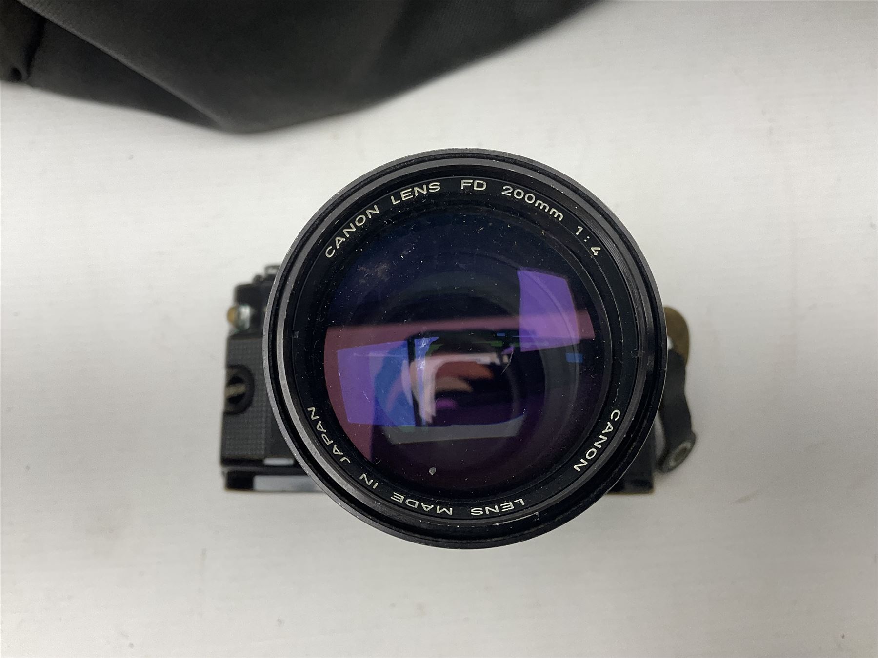 Canon A1 camera body, serial no 775843, together with 'Canon Lens FD 200mm 1:4 lens' serial no 24432, together with Semi Minolta folding camera, Canon 'Zoom FD 35-105mm 1:3.5-4.5' lens, Canon 'Macro Focusing Zoom 72mm Hanimex HMC 28-200mm' lens and other camera equipment  