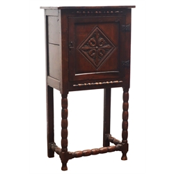  19th century oak cabinet with moulded frieze above styalized leaf carved lozenge panelled door, on bobbin turned supports joined by stretchers, W61cm, H119cm, D40cm  