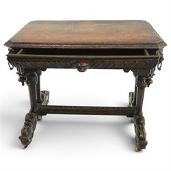 Victorian Jacobean Revival heavily carved oak centre table , rectangular top with canted corners and carved edge, fitted with single frieze drawer with central carved green-man handle with flanking gadrooning, the corners with lion masks, raised on fluted supports terminating to splayed stylised dolphin feet with castors, united by stretcher