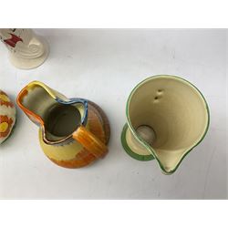Group of Art Deco ceramics, comprising Wadeheath jug painted in spiralled bands of blue, orange, yellow and brown, shape no. 707784, Royal Doulton Caprice pattern twin handled bowl, no. D5358, Arthur Wood wall pocket of typical stylised fan form with painted floral decoration, Arthur Wood vase of cornucopia form with red and grey floral decoration, Wadeheath jug of ribbed form with stylised handle, and two Hancock's Ivory Ware jugs, tallest example H26cm