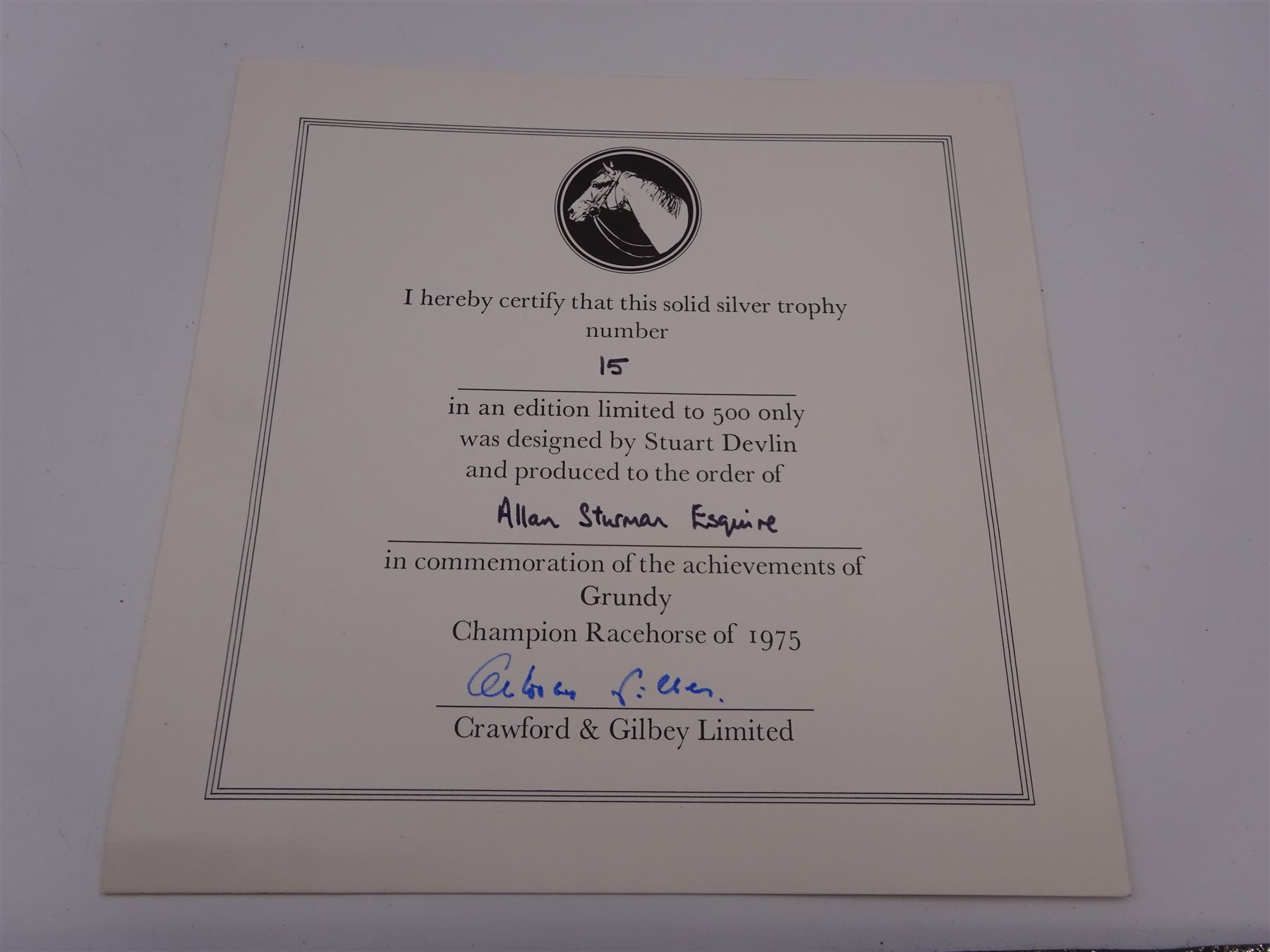 Modern limited edition silver salver, celebrating the achievements of Grundy, champion racehorse of 1975, each of circular form with gadrooned rim and plaque to centre depicting jockey mounted upon Grundy, designed by Stuart Devlin, limited edition no. 15/500, hallmarked London 1976, makers mark LH, D23cm, within silver lined fitted box and limited edition certificate 