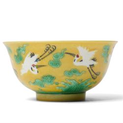 Chinese porcelain bowl, decorated with flying cranes amidst clouds and beneath a sea of wa...