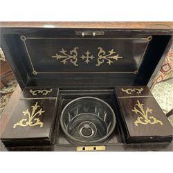 Early 19th century rosewood and brass inlaid tea caddy, of sarcophagus form, the front and hinged opening cover inlaid with brass scrolling panels, opening to reveal a compartmented interior with twin removable boxes with conforming inlaid brass detail to the hinged covers and zinc lining to the interiors, flanking a later glass mixing bowl, the whole upon four turned cylindrical feet, H21cm W36cm D20cm