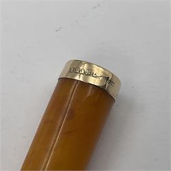 Two cheroot holders, one example with 9ct gold collar, together with two Victorian silver cheroot holder cases, both of typical form, one with personal engraving to cover, hallmarked Sampson Mordan & Co, London 1896