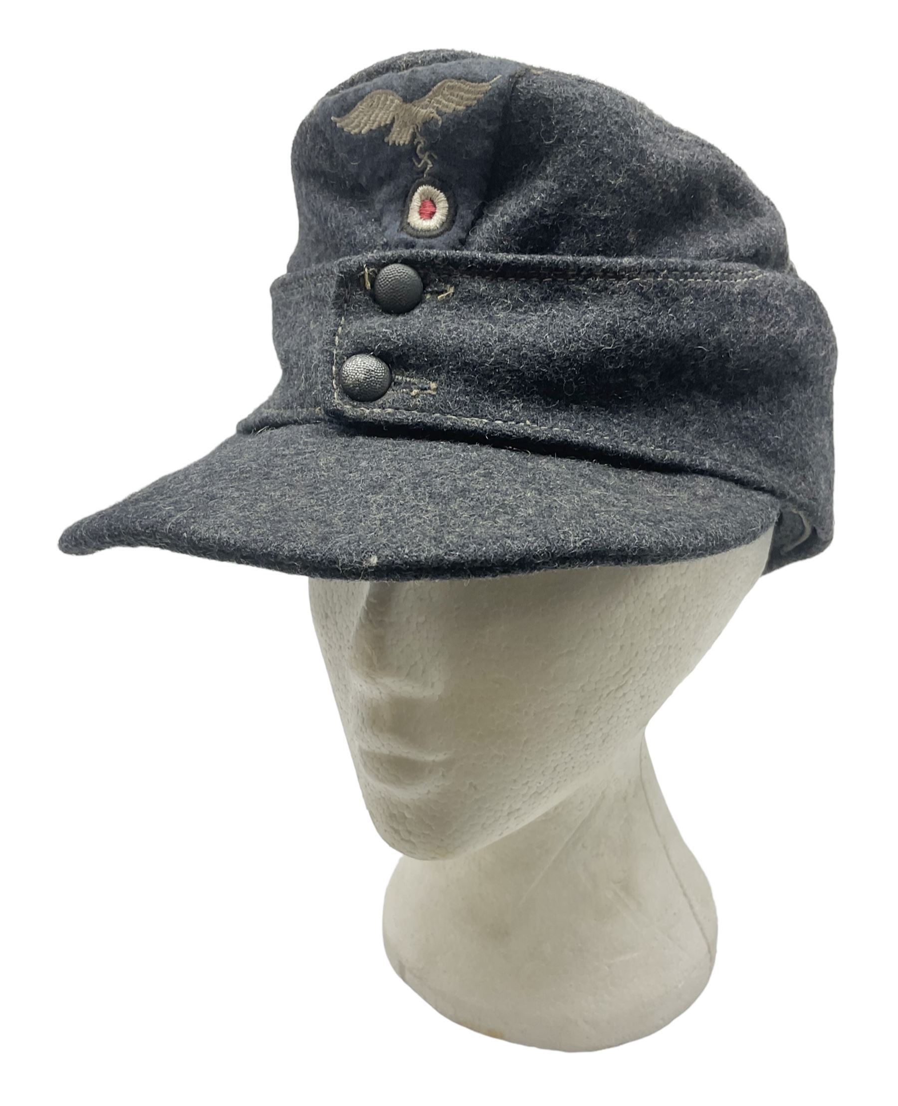 WW2 German Luftwaffe M43 field cap with triangular cloth eagle and roundel badge; marked '1944 ?/0501/0015 57'