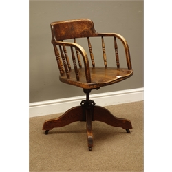  Early 20th century oak swivel office armchair, turned spindle back, on four splayed supports  