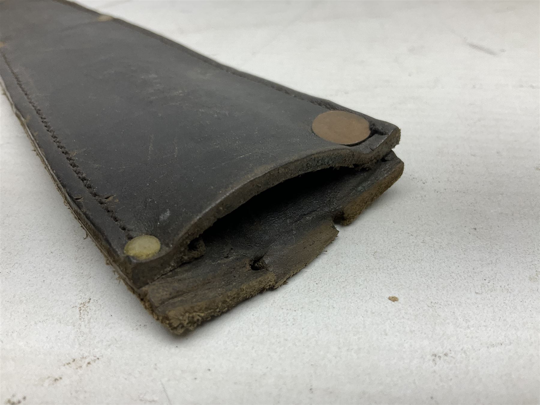 Fairburn and Sykes Commando fighting knife, 3rd pattern with 17cm double edged blade and copperised grip; no markings; in cut-down plain leather sheath L31.5cm