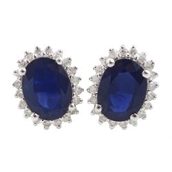 Pair of 14ct white gold oval sapphire and round brilliant cut diamond stud earrings, stamped 585