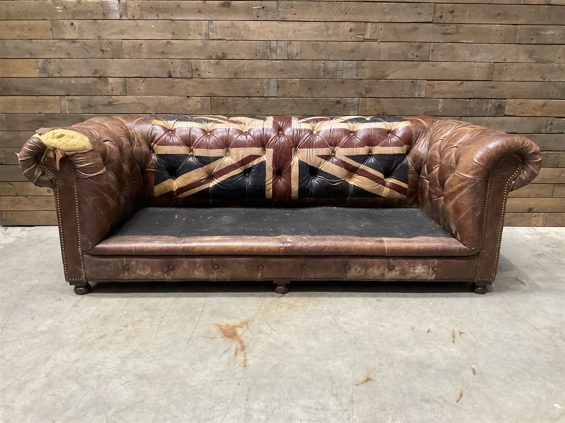 Chesterfield two sofa upholstered in brown leather, with Union Jack pattern, no seat cushions - located in storage, viewing not available