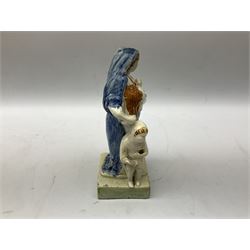 Late 18th century Prattware figure representing Charity, modelled as a mother with baby in her arms and two small children clutching at her robes, upon a square base, overall H21cm.