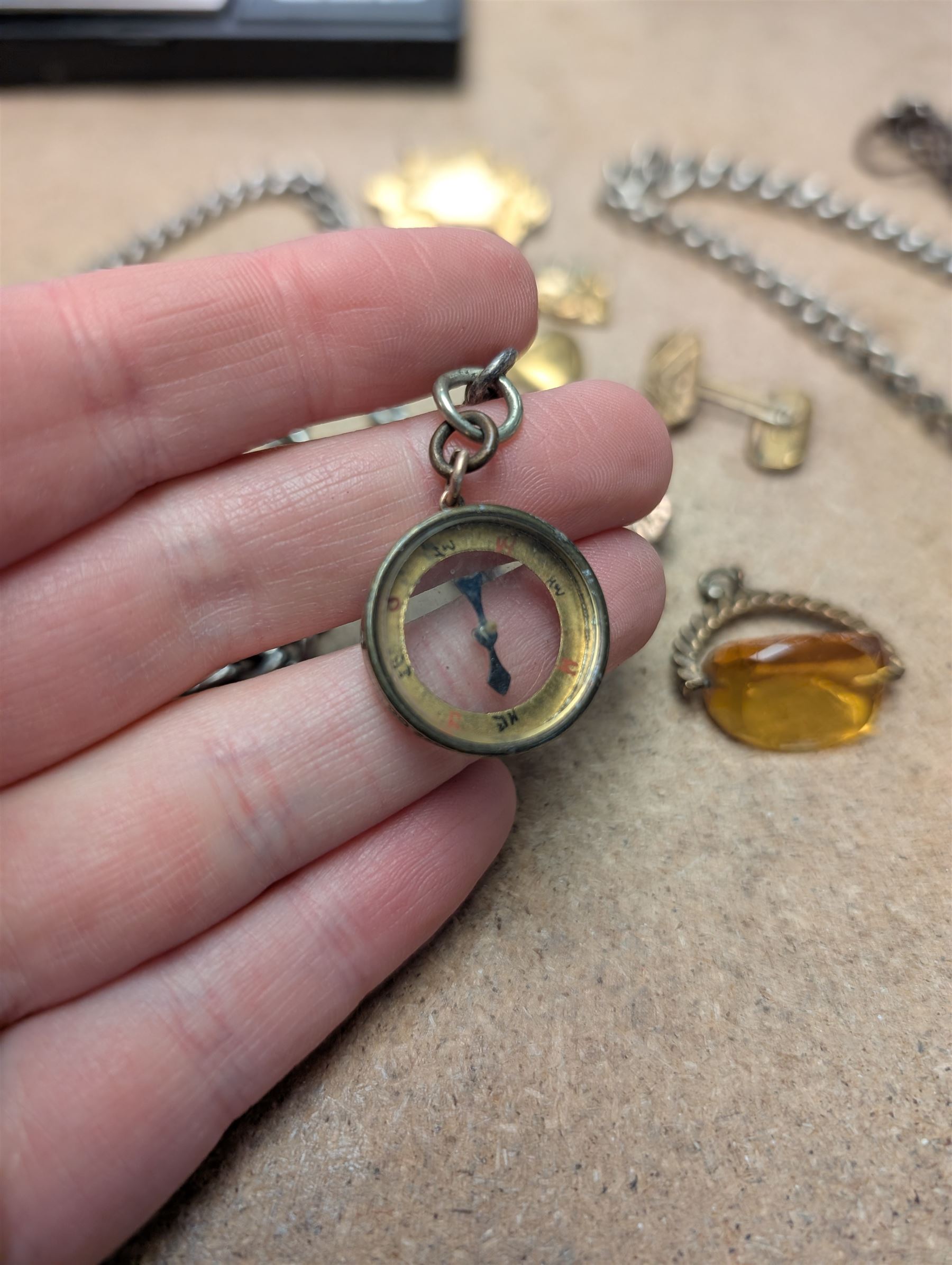 9ct gold mounted compass charm and a 9ct gold wedding band, hallmarked, together with a gold plated American Waltham Watch Co pocket watch, a silver watch chain and other gilt metal jewellery