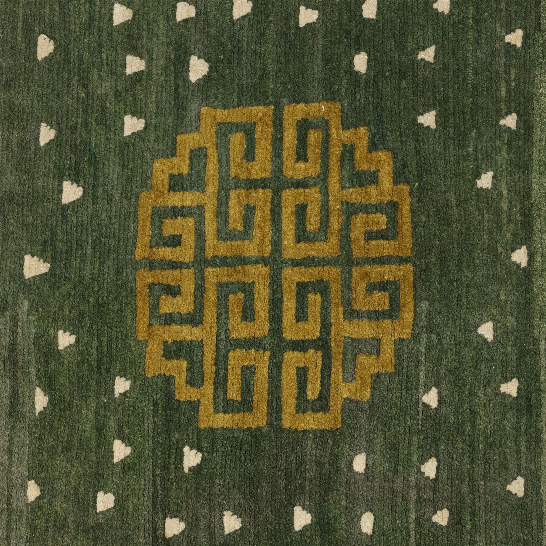 Chinese Ningxia rug, green field with central stylized shou medallion and scattered cloud motifs within key fret borders in shades of olive green, fringe ends partially detached 