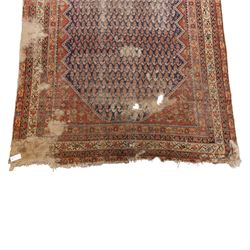 West Persian Kurdish vintage carpet, indigo field decorated with an all-over repeating boteh design arranged in diagonal rows framed by angular spandrels and enclosed by multiple geometric borders in a palette of indigo blue, madder red, soft green and ivory