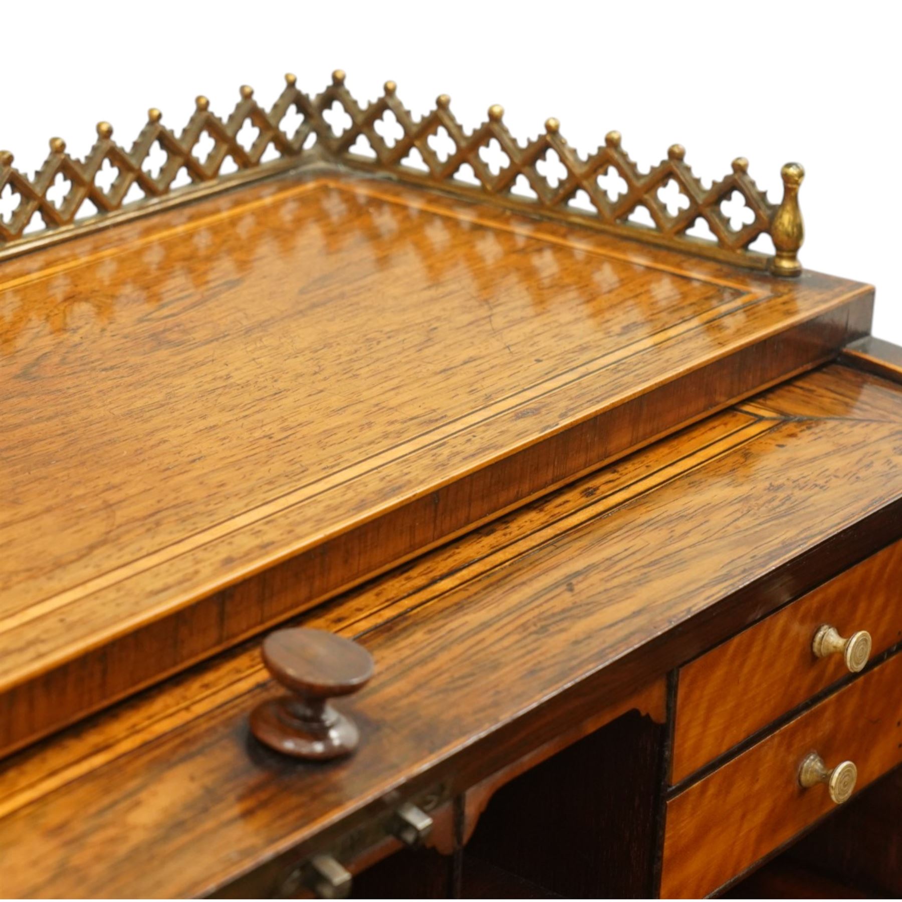 Regency period inlaid mahogany Ladies cylinder writing desk, the rectangular satinwood banded top with raised pierced brass three-quarter gallery, over a cylindrical roll-top enclosing a satinwood fitted interior with pigeonholes, correspondence drawers, ink wells and a sliding hinged writing slope, the base fitted with single frieze drawer, raised on square tapering supports
Provenance: Kirkham Hall
