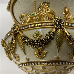 Franklin Mint House of Faberge; The Faberge Imperial Carousel Egg, with a carousel that revolves to the sound of the musical box operated by the winding key finial, H27cm