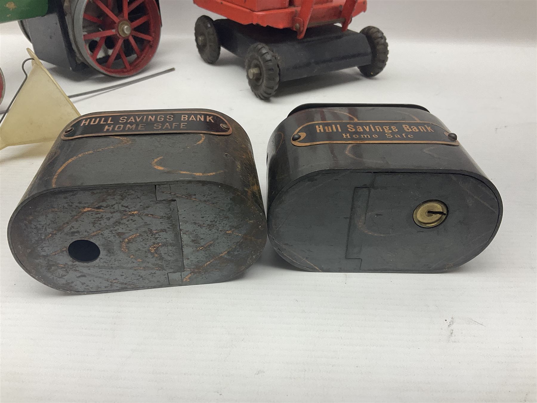 Mamod TE1a steam traction engine with burner, bunker, steering rod and funnel; red and black painted Tri-ang tin-plate Jones KL44 mobile crane; and two Hull Savings Bank Home Safe money boxes; all unboxed (4)